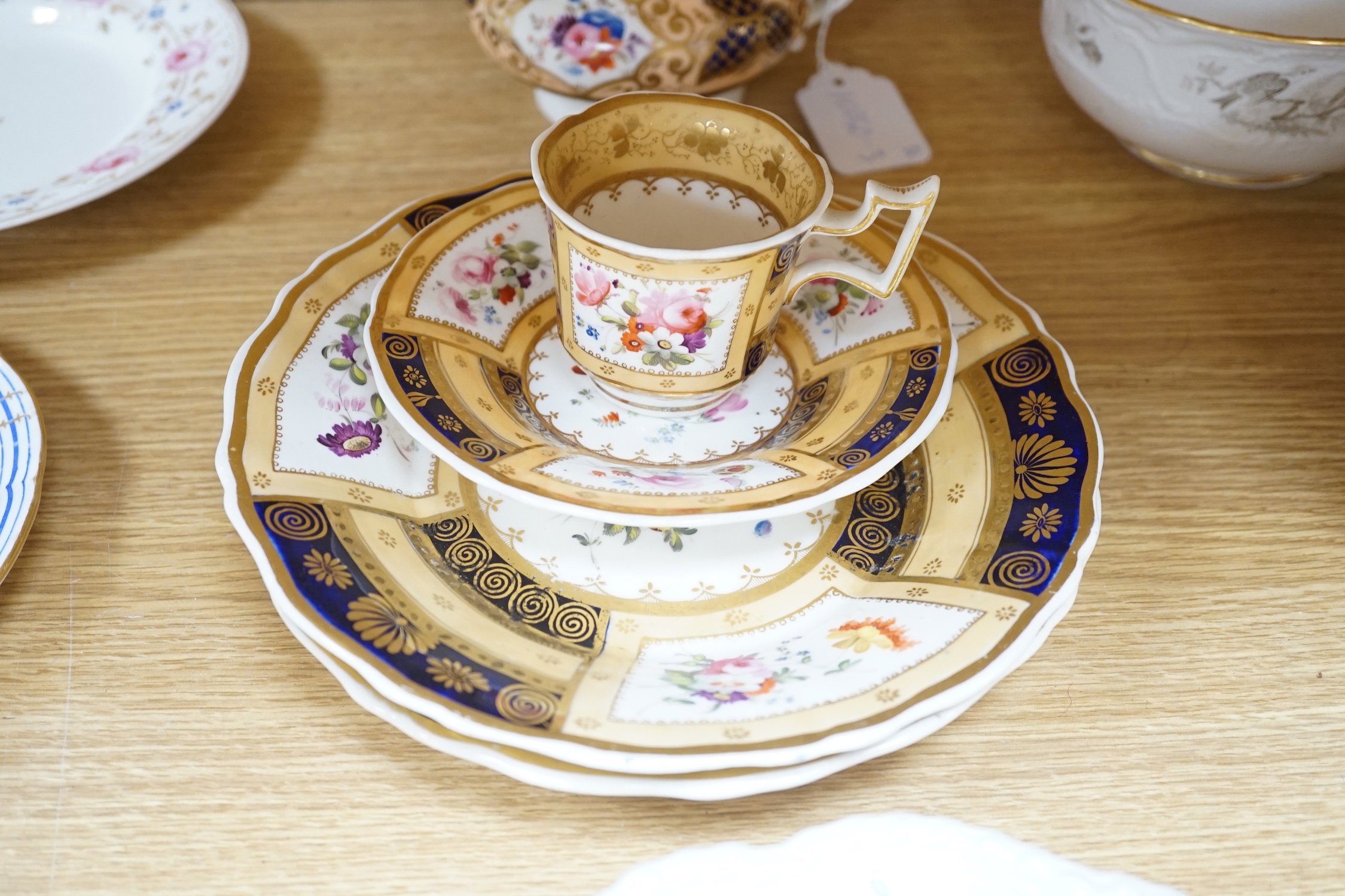 A collection of early 19th century decorative porcelain painted with flowers and a gilt blue ground plus other (12)